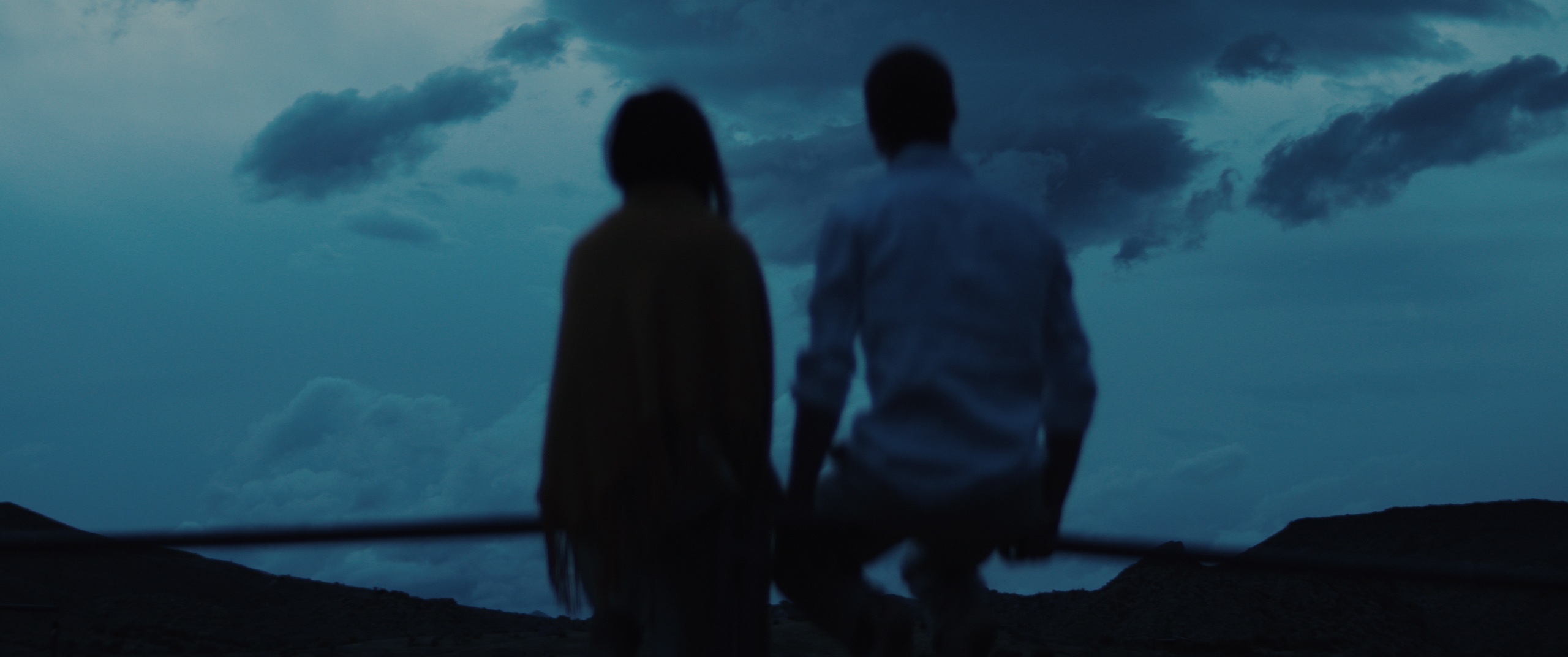 The Golden Hour — a couple at dusk overlooking the high desert, film still written and directed by Zane Ra