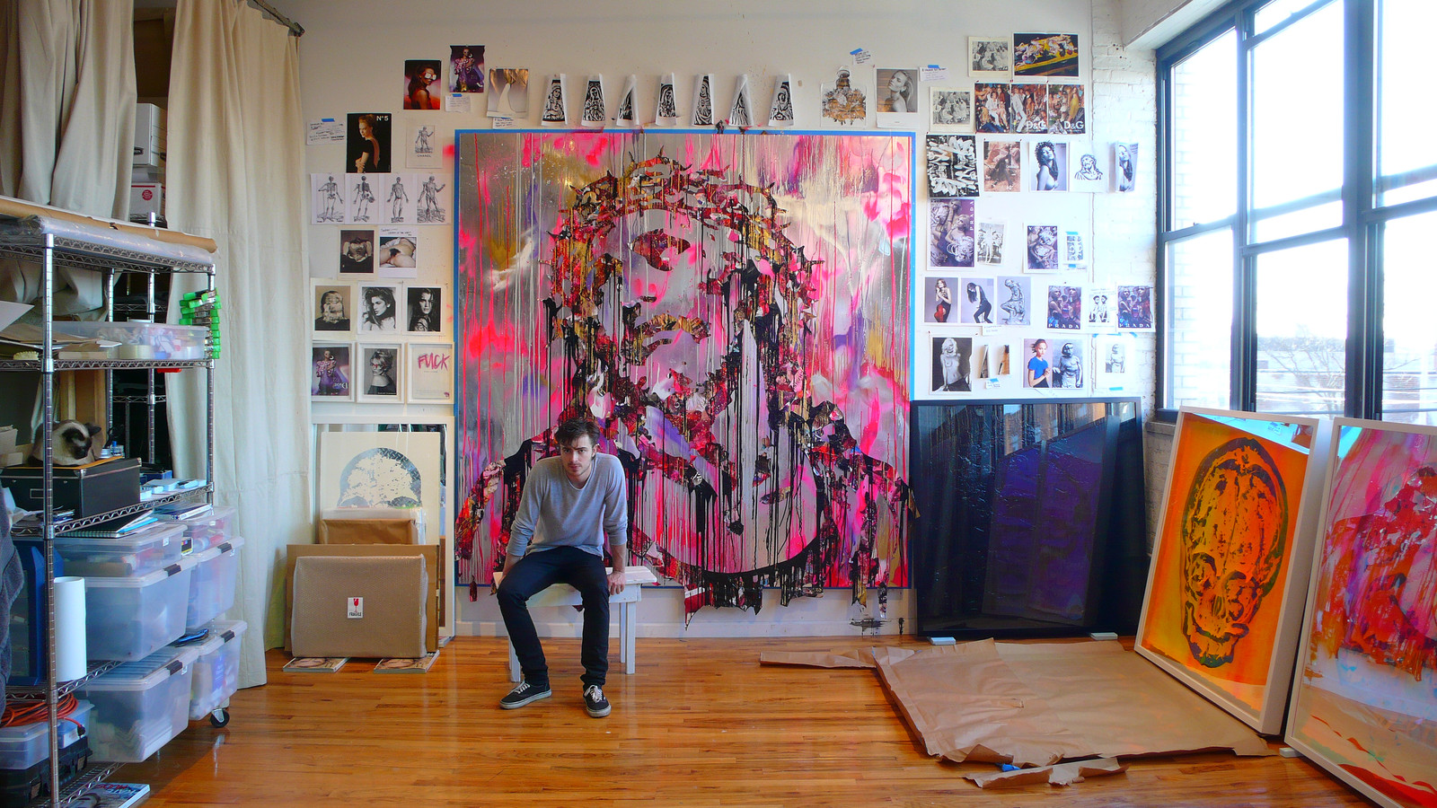Zane Lewis in his New York City studio, 2009, seated before a large mixed-media portrait painting surrounded by works and reference walls